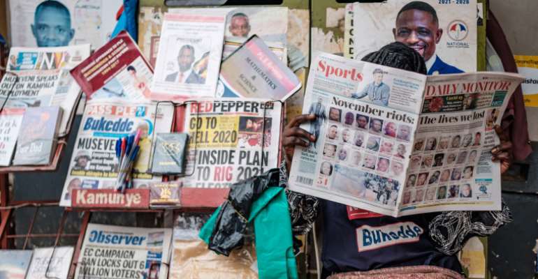 Newspapers covering upcoming elections are seen in Kampala, Uganda, on January 4, 2021. Security forces have harassed and detained journalists covering opposition candidates in the election. (AFP/Sumy Sadurni)