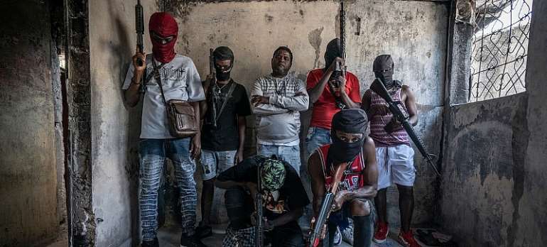 Giles Clarke: Gang members brandish their weapons in the Delmas 3 neighbourhood of the Haitian capital, Port-au-Prince.