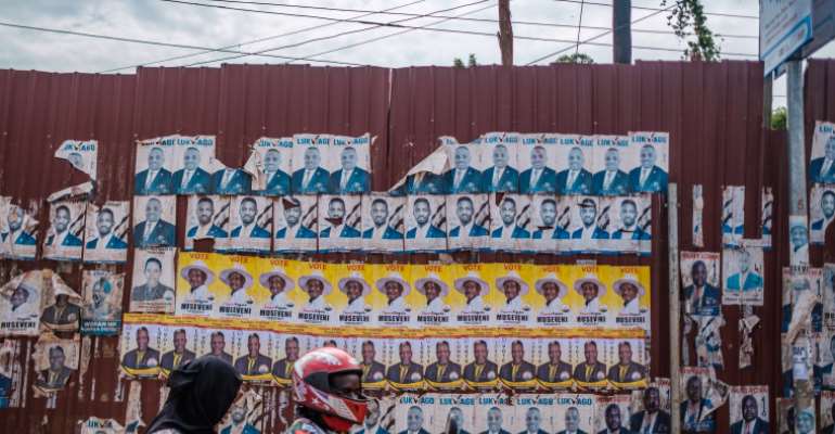 Candidate posters are seen in Kampala, Uganda, on January 6, 2021. CPJ joined a letter to the country's president today urging the government to maintain internet access through the election. (AFP/Sumy Sadurni)