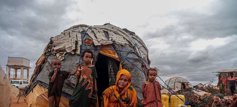 IOM/Raber Aziz: Members of a family displaced by drought and conflict rest outside their tent.