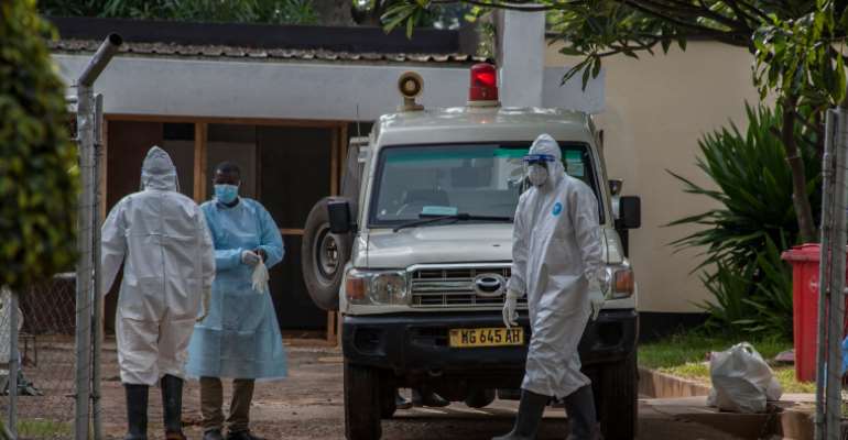 Medical personnel are seen in Lilongwe, Malawi, on January 18, 2021. Police recently attacked journalist Henry Kijimwana Mhango while he was reporting on the coronavirus pandemic. (AFP/Amos Gumulira)