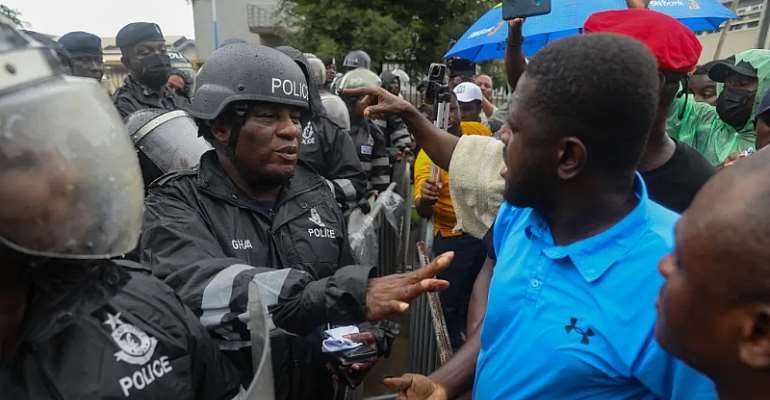  A Ghanaian police officer gestures towards protestors during a demonstration in Accra on September 23, 2023. Mohammed Aminu M. Alabira, a correspondent for Citi FM, was covering the ruling New Patriotic Party parliamentary primaries on January 27, 2024