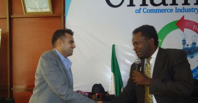 Africa's youngest billionaire, Ashishi J. Thakkar  in  a warm hand shake with PHCCIMA president, Emeka Unachukwu