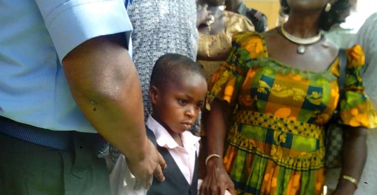 Moses Illoba, the recovered child been held by his grandmother and the CP