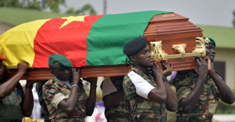 The remains of a Cameroonian soldier being carried in Yaounde by his colleagues