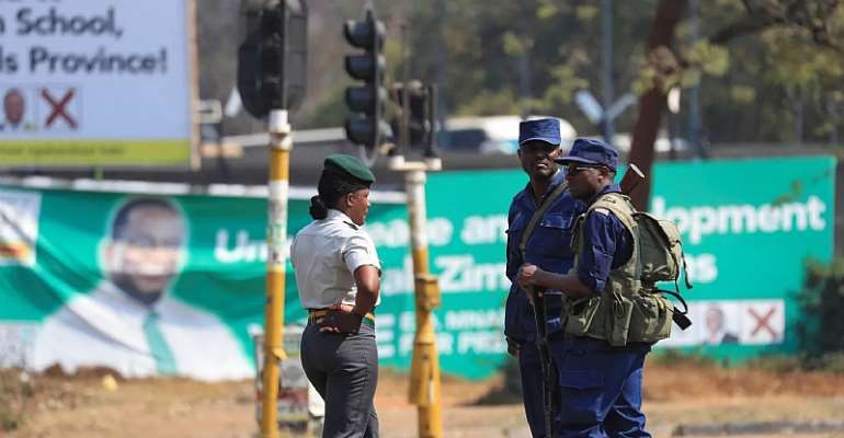 Zimbabwean police stand guard in Harare in 2023. CPJ called on a minister of state for Zimbabwe's Midlands Province to immediately rescind an order barring journalists Sydney Mubaiwa 