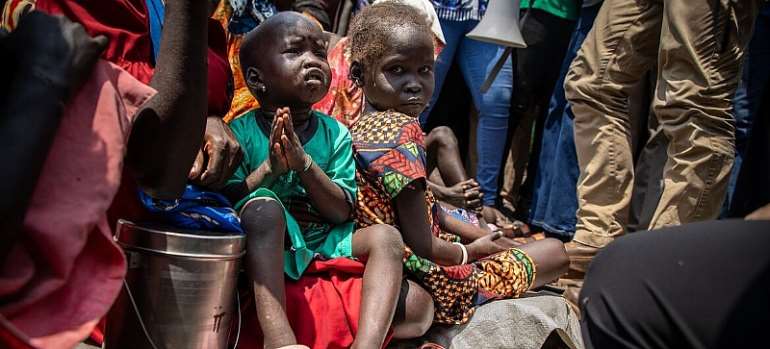 UNOCHA/Adedeji Ademigbuji Children displaced by the recent violence in Jonglei State, South Sudan, sit outside a church, home to thousands of displaced people