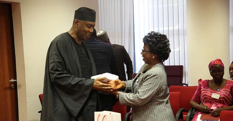 Senate President​ giving the leader of the QCOGA delegation, National President, Dr. Frances Funmi Ajose​, a souvenir from the office.