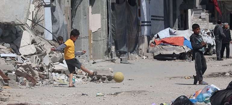 UN News: Children play football amidst the rubble of Gaza City