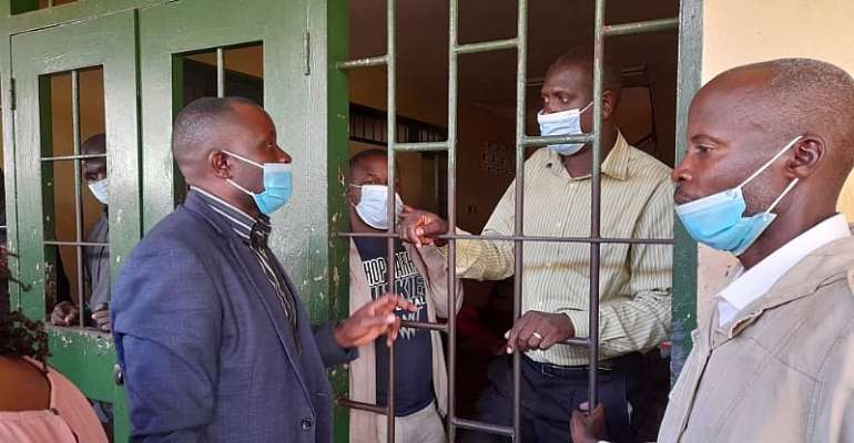 Journalists Darious Magara (in jail cell, left) and Pidson Kareire (in jail, right) 