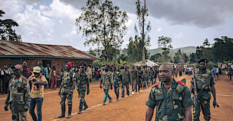 Soldiers and militia members are seen in Ituri province, Democratic Republic of Congo, on September 19, 2020. Unidentified men in military uniform recently threatened to kill journalist Parfait Katoto in Ituri. (AFP/Alexis Huget)