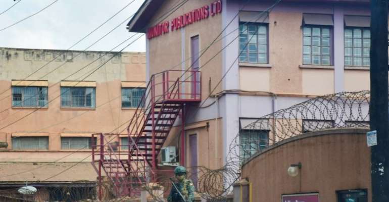 A member of Uganda People's Defence Forces stands at the headquarters of Nation Media Group-Uganda, a building in Kampala, Uganda that houses the Daily Monitor and radio broadcasters KFM and Dembe FM,