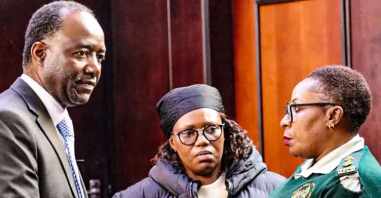 Zimbabwe Independent editor Faith Zaba, center, with her lawyer, Chris Mhike, left, speak to an officer at Zaba's appearance at the Harare Magistrate's Court earlier today. (Photo: Lovejoy Mutongwiza)