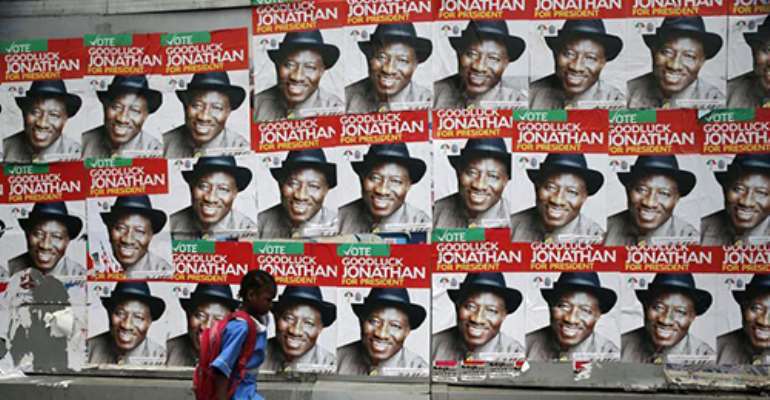 A schoolgirl walks past campaign posters for Nigerian President Goodluck Jonathan in Lagos. Journalists covering the election campaign say they are being attacked. (Reuters/ Akintunde Akinleye)