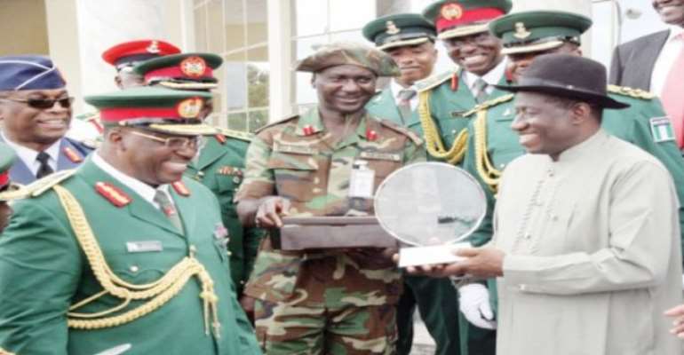 PHOTO: A FILE PHOTO SHOWING PRESIDENT GOODLUCK JONATHAN RECEIVING A PLAQUE FROM THE CHIEF OF ARMY STAFF, LT. GENERAL ABDULRAHAMAN DAMBAZAU. PHOTO: NAN.