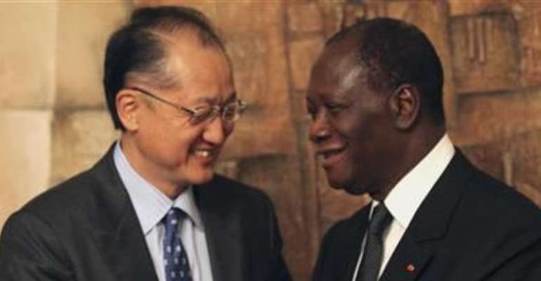 IVORY COAST'S PRESIDENT ALASSANE OUATTARA (R) GREETS WORLD BANK PRESIDENT JIM YONG KIM AFTER HIS SPEECH AT THE PRESIDENTIAL PALACE IN ABIDJAN SEPTEMBER 4, 2012.
