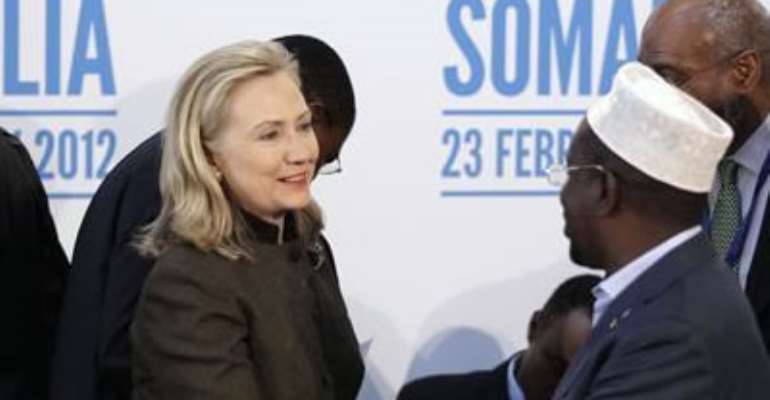 SECRETARY OF STATE HILLARY CLINTON (L) SHAKES HANDS WITH THE PRESIDENT OF SOMALIA, SHEIKH SHARIF AHMED, DURING THE LONDON CONFERENCE ON SOMALIA AT LANCASTER HOUSE IN LONDON FEBRUARY 23, 2012.