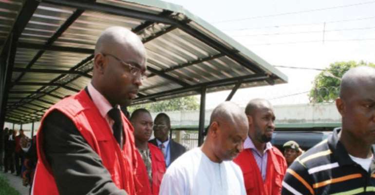 MR FRANCIS ATUCHE SANDWICHED BETWEEN OPERATIVES OF THE EFCC.