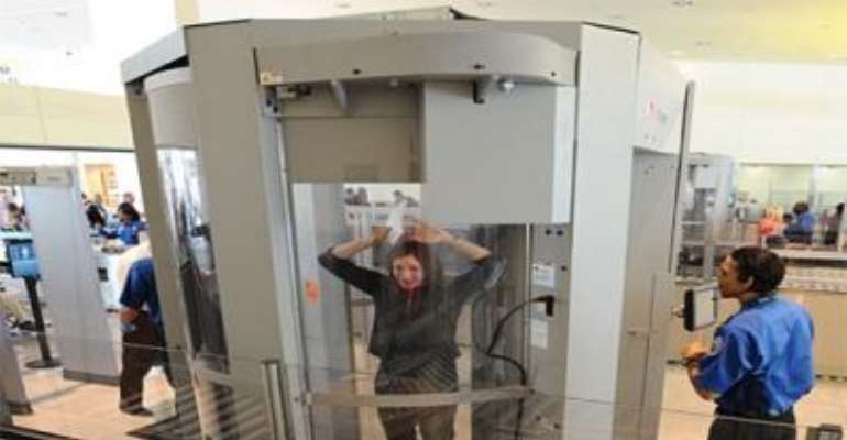 PHOTO: A TRAVELLER IN A SCREENING MACHINE AT A US AIRPORT.