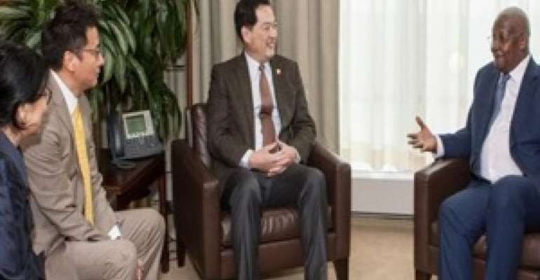 Sam Kutesa, right, meets in his PGA office in May with Chinese businessman Ruiyun Wang