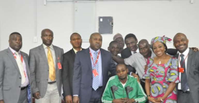 EFCC DIRECTOR OF OPERATIONS OLAOLU ADEGBITE (M) IN A GROUP PHOTO WITH MEMBERS OF THE DISABLED PERSONS FOUNDATION AT THE EFCC HEADQUARTERS ABUJA. FEBRUARY 19, 2013