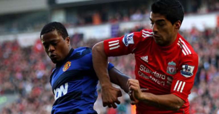 PATRICE EVRA (L) AND LUIS SUAREZ (R) AS MANCHESTER UNITED DRAW 1-1 WITH LIVERPOOL AT ANFIELD ON SATURDAY