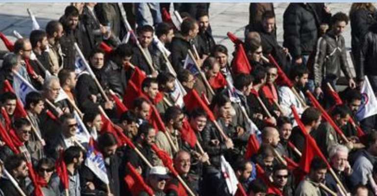 PROTESTERS FROM THE COMMUNIST-AFFILIATED TRADE UNION PAME MARCH DURING A RALLY IN FRONT OF THE PARLIAMENT DECEMBER 1, 2011.