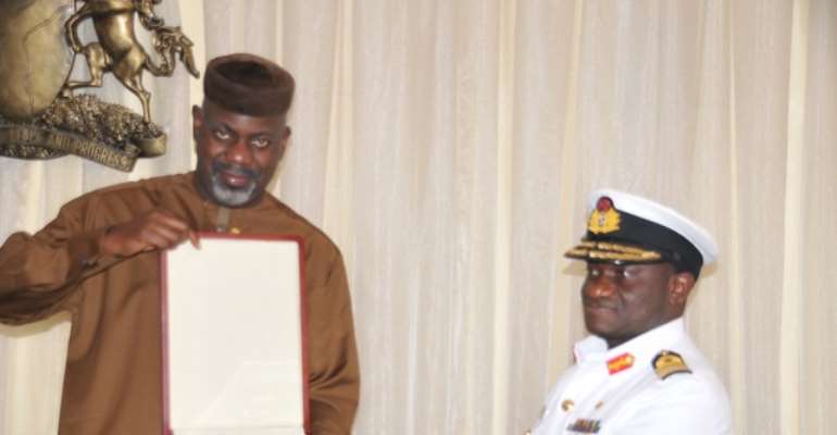CROSS RIVER STATE GOVERNOR (L), SENATOR LIYEL IMOKE RECEIVING A SOUVENIR FROM THE FLAG OFFICER COMMANDING (FOC), EASTERN NAVAL COMMAND, NIGERIAN NAVY, REAR ADMIRAL USMAN JUBRIN, WHEN HE PAID A COURTESY VISIT TO THE GOVERNMENT HOUSE, CALABAR, TUESDAY.