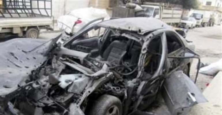 A DAMAGED CAR IS SEEN IN BAB AMRO, IN THE CITY OF HOMS FEBRUARY 15, 2012.