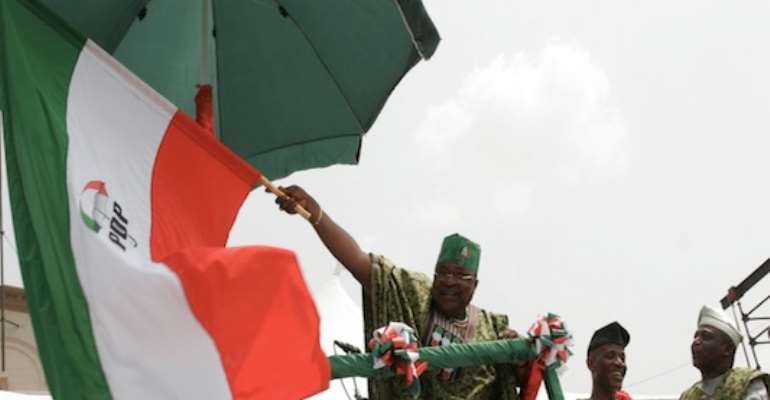 OYO STATE GOVERNOR ADEBAYO ALAO-AKALA WAVES A SYMBOLIC PDP FLAG RECEIVED FROM ACTING NATIONAL CHAIRMAN, DR HALIRU BELLO MOHAMMED AT THE SOUTH-WEST RALLY IN IBADAN, OYO STATE TODAY, FEBRUARY 08, 2011.