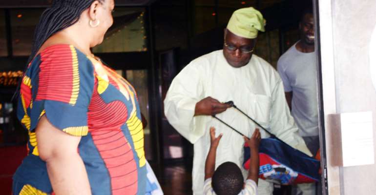 PHOTO: FORMER PRESIDENT OLUSEGUN OBASANJO (R) PLAYS WITH A KID AT THE PRESIDENTIAL WING OF THE MURTALA MUHAMMED AIRPORT, IKEJA, LAGOS RECENTLY.