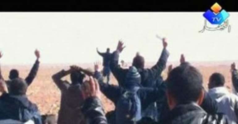 HOSTAGES ARE SEEN WITH THEIR HANDS IN THE AIR AT THE IN AMENAS GAS FACILITY IN THIS STILL IMAGE TAKEN FROM VIDEO FOOTAGE TAKEN ON JANUARY 16 OR JANUARY 17, 2013.