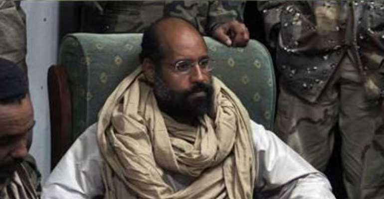 SAIF AL-ISLAM IS SEEN AFTER HIS CAPTURE, IN THE CUSTODY OF REVOLUTIONARY FIGHTERS IN OBARI, LIBYA