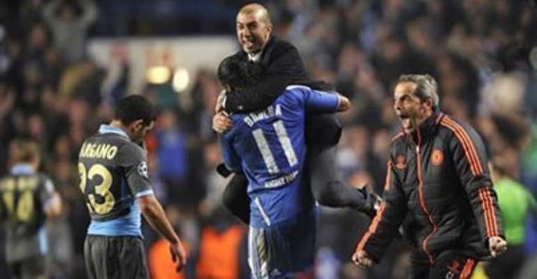 CHELSEA'S MANAGER ROBERTO DI MATTEO (TOP) AND CHELSEA'S DIDIER DROGBA CELEBRATE AFTER DEFEATING NAPOLI IN THEIR CHAMPIONS LEAGUE SOCCER MATCH AT STAMFORD BRIDGE IN LONDON MARCH 14, 2012.