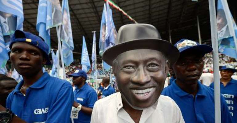 A supporter wearing a mask representing Nigeria's President Goodluck Jonathan attends a campaign meeting of the ruling People's Democratic Party candidate in Port Harcourt on January 28, 2015.  By Pius Utomi Ekpei (AFP/File)