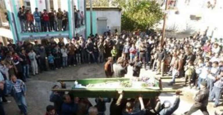 ANTI-GOVERNMENT PROTESTERS CARRY THE COFFIN OF ABDUL HALEEM BAQOUR DURING HIS FUNERAL IN HULA NEAR HOMS DECEMBER 10, 2011.