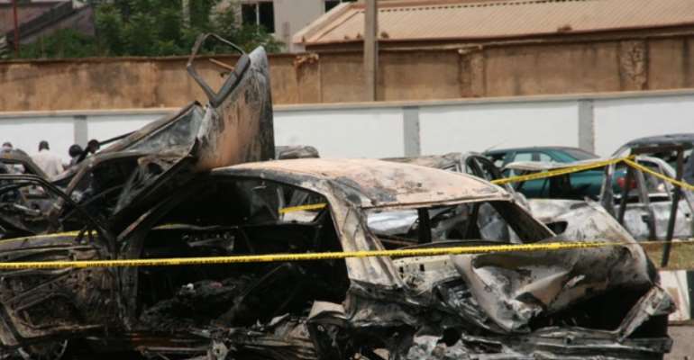REMAINS OF VEHICLES AT THE POLICE HEADQUARTERS CAR PARK AFTER THE BOMB EXPLOSION AT THE FORCE HEADQUARTERS IN ABUJA.
