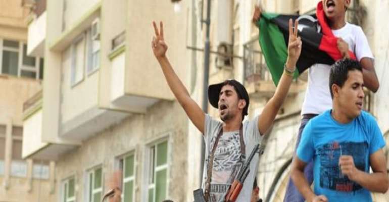 REBEL FIGHTERS CELEBRATE AFTER THE CAPTURE OF MUAMMAR GADDAFI'S COMPOUND IN TRIPOLI TUESDAY, AUGUST 23, 2011. PHOTO CREDIT: REUTERS.
