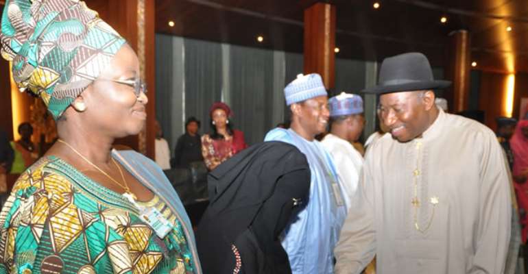 PRESIDENT JONATHAN SHAKING HANDS WITH A MEMBER OF THE COMMITTEE ON DIALOGUE & PEACEFUL RESOLUTION OF SECURITY CHALLENGES IN THE NORTH, BARR AISHA WAKILI DURING THEIR INAUGURATION IN ABUJA. APRIL 24, 2013