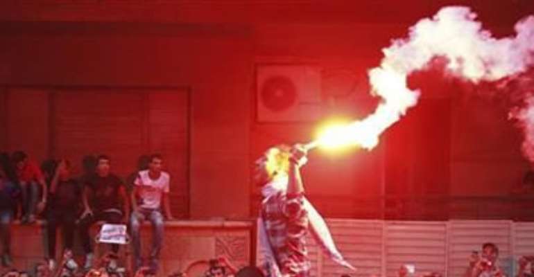 PEOPLE SHOUT SLOGANS AND LIGHT FLARES IN FRONT OF THE U.S. EMBASSY DURING A PROTEST AGAINST WHAT THEY SAID WAS A FILM BEING PRODUCED IN THE UNITED STATES THAT WAS INSULTING TO THE PROPHET MOHAMMAD, IN CAIRO SEPTEMBER 11, 2012.