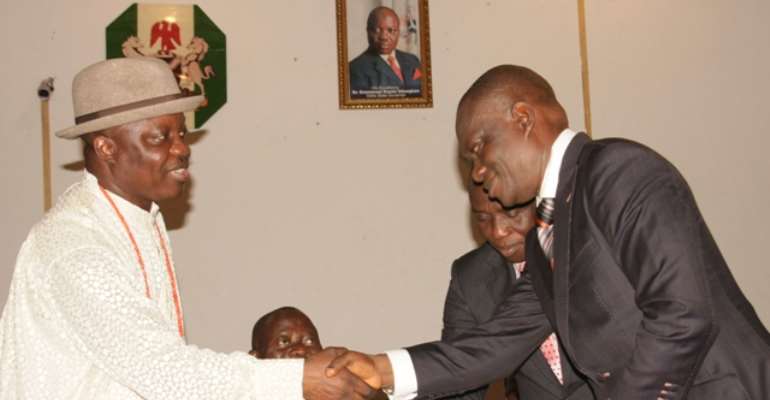 DELTA STATE GOVERNOR, DR EMMANUEL UDUAGHAN (L) CONGRATULATES MR MACAULAY OVUOZOURIE ON HIS APPOINTMENT WHILE EDO STATE GOVERNOR, COMRADE ADAMS OSHIOMHOLE LOOKED ON INSIDE THE GOVERNOR'S OFFICE ASABA, TODAY, JUNE 01, 2011.
