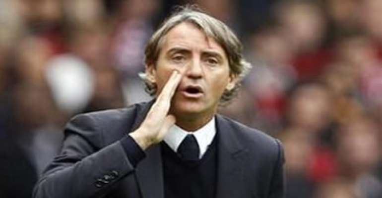 MANCHESTER CITY'S MANAGER ROBERTO MANCINI INSTRUCTS HIS TEAM DURING THEIR ENGLISH PREMIER LEAGUE SOCCER MATCH AGAINST MANCHESTER UNITED AT OLD TRAFFORD, OCTOBER 23, 2011.
