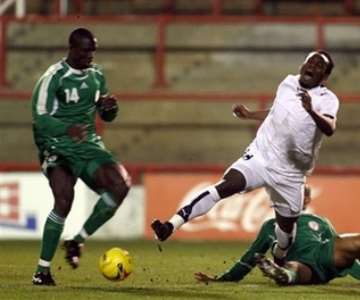Ghana's Michael Essien, center, is brought down by Nigeria's George Abbey during their International friendly soccer match at Griffin Park Stadium, London, Tuesday Feb. 6, 2007. (AP Photo/Graham Hughes )