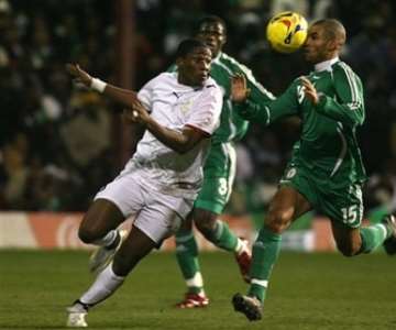 Nigeria's George Abbey, right, clears the ball away from Ghana's Asamoah Gyan during their International friendly soccer match at Griffin Park Stadium, London, Tuesday Feb. 6, 2007. (AP Photo/Graham Hughes )