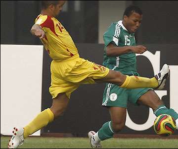 Ike Uche looks to send a cross into Benin's penalty area as Nigeria search for an early goal to settle their nerves