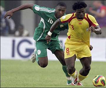 Benin's Nigerian-born forward Razak Omotoyossi leaves Dickson Etuhu behind as he searches for the opening goal