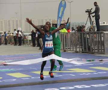 HALIMA HUSSEIN KAYO CROSSING THE FINISH LINE AS THE FIRS T FEMALE