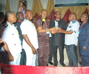 UMEAGBALASI WITH OTHER CSO LEADERS PRESENTING THE AWARD TO HE, PETER OBI