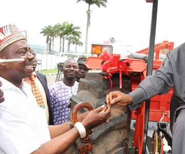 Gov. Theodore Orji of Abia state presenting key to a tractor to one of the farmers in the state HRH Eze Philip Ajuomiwe in Umuahia.