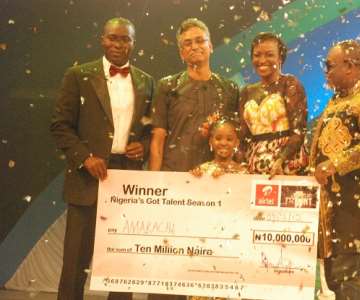 MD/CEO, Airtel Nigeria, Rajan Swaroop (2nd L), Celebrity judges on Nigeria''s Got Talent (NGT) Season One, Yibo Koko (L), Kate Henshaw-Nuttal(2nd r) and Dan Foster (r) with NGT Season One Winner, Amarachi Uyanne on stage shortly after the 8 years old received the cheque of N10 Million grand prize at the OMG Studio in Lagos....Saturday.